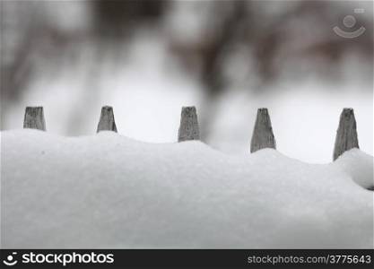 Wood fence covered with snow on winter season