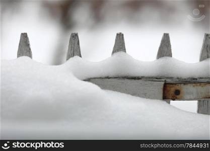 Wood fence covered with snow on winter season