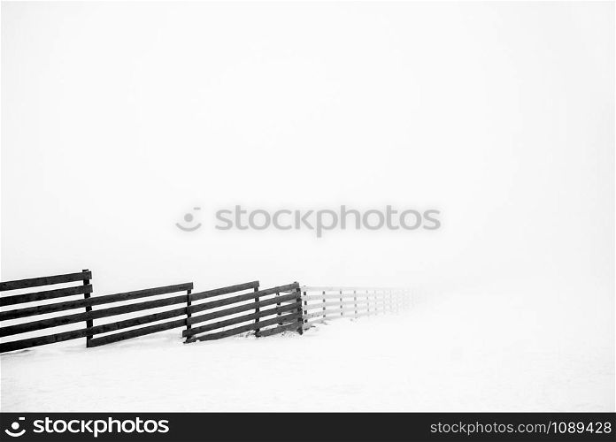Wood fence going to infinity in winter for. Wood fence in snow.