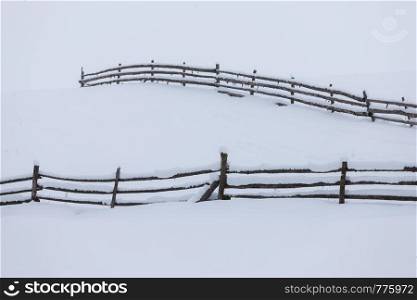 Wood fence in snow. Minimalistic winter landscape
