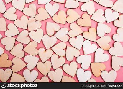Wood hearts texture on pink background, valentine day concept