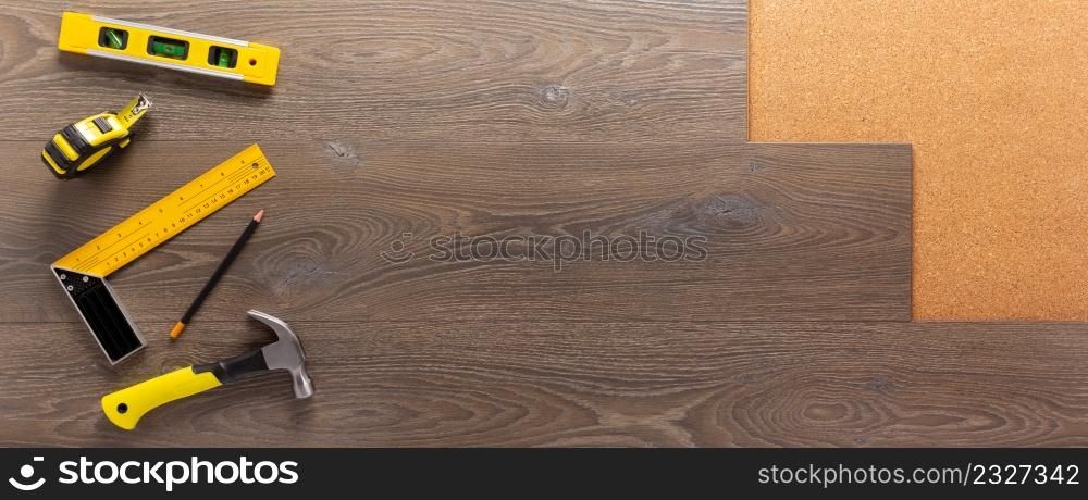 Wood laminate and tools at floor background texture. Wooden laminate top view