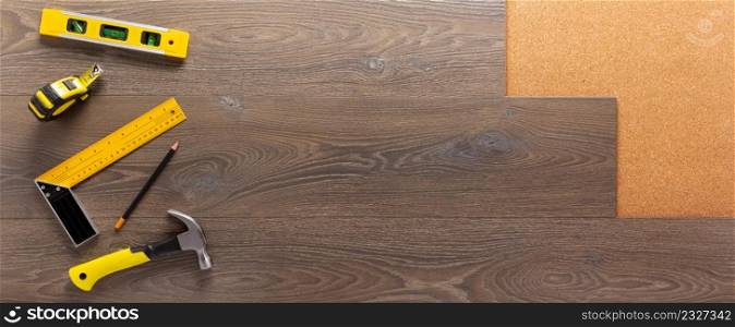 Wood laminate and tools at floor background texture. Wooden laminate top view