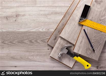 Wood laminate background and tools at floor texture. Wooden laminate top view