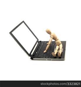 wood mannequin sitting on a laptop isolated on white background