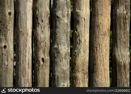 Wood natural striped trunks wall, fence, traditional wood architecture