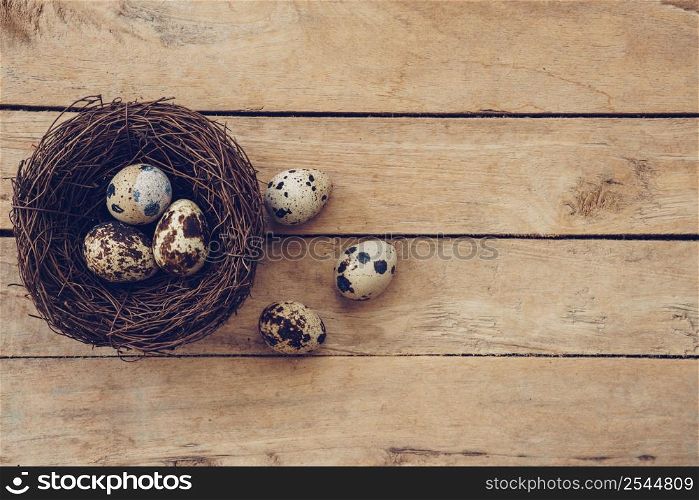 Wood nest and easter eggs on wooden background and texture with copy space.