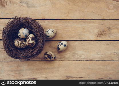 Wood nest and easter eggs on wooden background and texture with copy space.