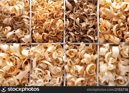 Wood shavings in box on table background. Wooden shaving from old plank board texture