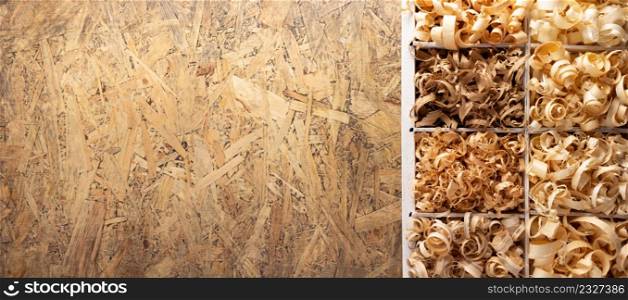 Wood shavings in box on table background. Wooden shaving from old plank board texture