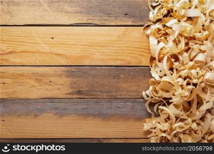 Wood shavings on table background. Wooden shaving at old plank board texture