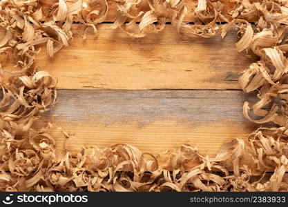 Wood shavings on table background. Wooden shaving at old plank board texture