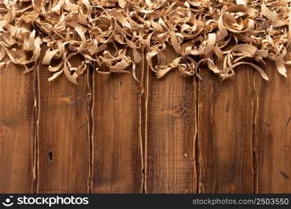 Wood shavings on table background. Wooden shaving at old plank board texture
