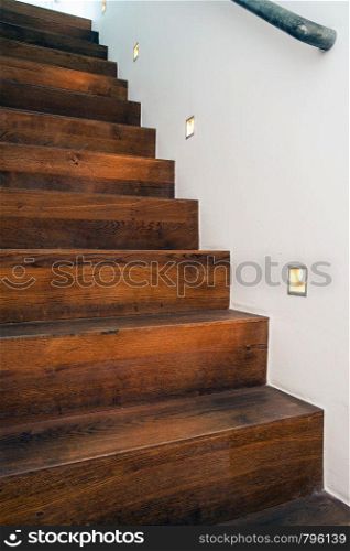 Wood stairs by night with led light in the white wall modern design abstract. Wood stairs by night with led light in the white wall modern design