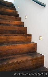 Wood stairs by night with led light in the white wall modern design abstract. Wood stairs by night with led light in the white wall modern design