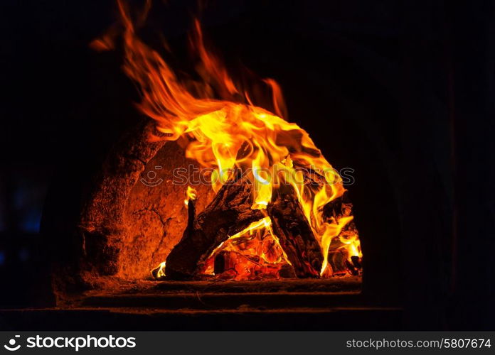 Wood stove with fire and blaze