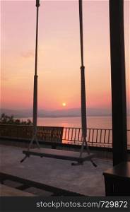 Wood swing of beautiful sunset on Khuean Srinagarindra National Park at Kanchanaburi , Thailand and sky for travel in holiday relax time