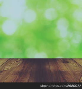 Wood table and bokeh abstract nature green background with vintage effect
