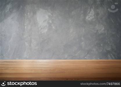 Wood table and cement wall background