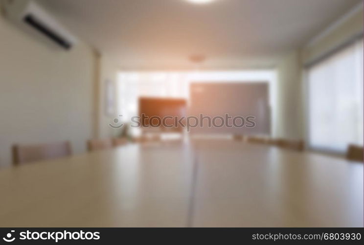 wood table and chair in meeting conference room in office workpace - blur for background