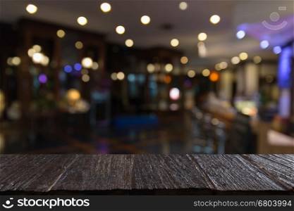 wood table for montage or display your product with blur background of pub bar restaurant