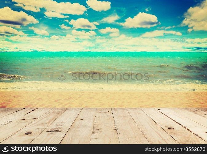Wood table sand beach sea and in sky clouds with vintage tone.