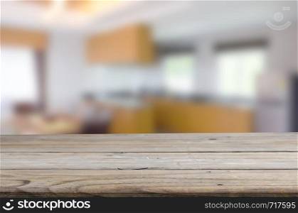 wood table top and Abstract Blurred image Kitchen Interior. Can be used for display or montage your products.