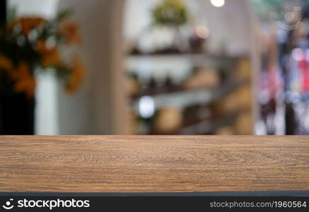 Wood table top in front of abstract blurred background. Empty wooden table space for text marketing promotion. blank wood table copy space for background