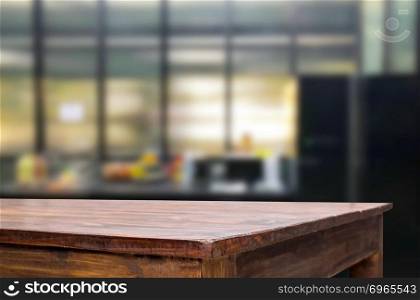 Wood table top on blur kitchen or cafe room background .For montage product display design key visual layout.