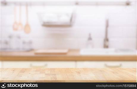 Wood table top on blur kitchen room background. can be used for display or montage your products