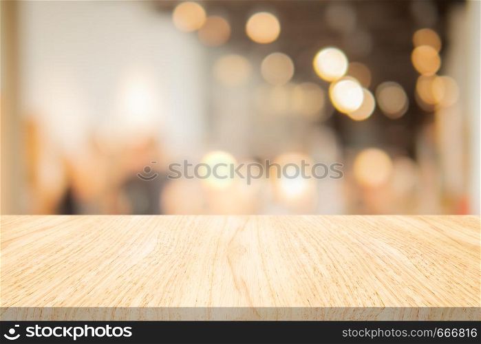 Wood table top on blurred background at coffee shop, Space for montage your products