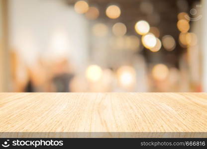 Wood table top on blurred background at coffee shop, Space for montage your products