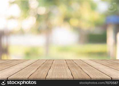 Wood table top on blurred background at garden,for montage your products