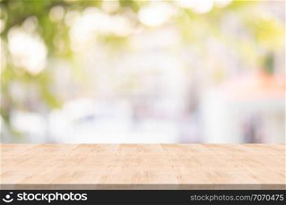wood table top on blurred background from garden, Space for montage your product