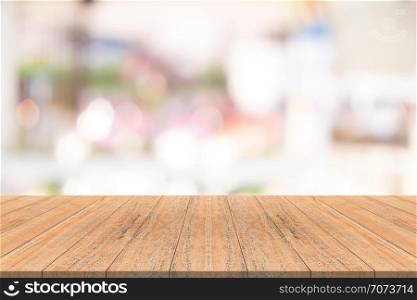 Wood table top on blurred background from shopping mall, Space for montage your products