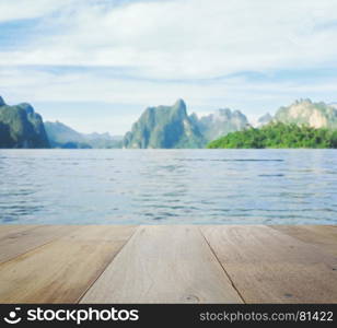 wood table top on blurred beautiful landscape with mountain and lake