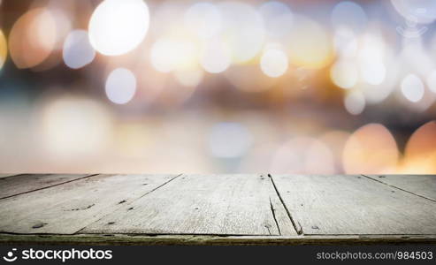 Wood table top on bokeh abstract background and used for montage or display products.