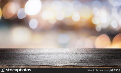 Wood table top on bokeh abstract background and used for montage or display products.