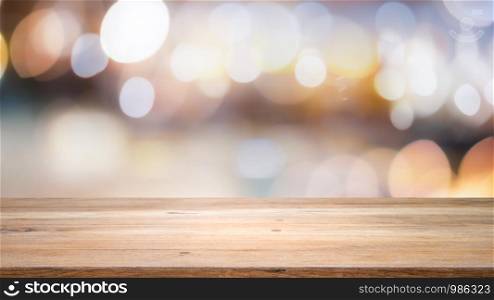 Wood table top on bokeh abstract background and used for montage or display products.