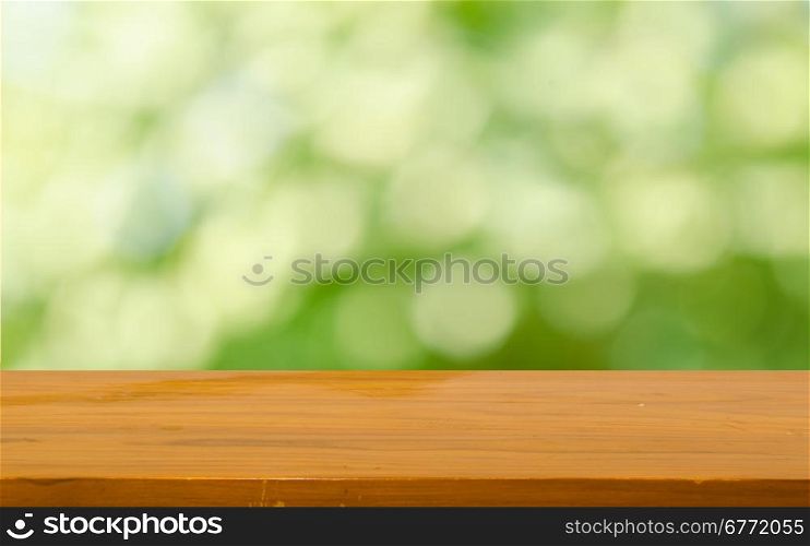 Wood table top on bokeh green background &#xD;