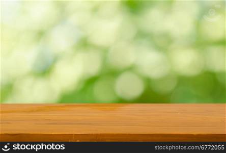 Wood table top on bokeh green background &#xD;