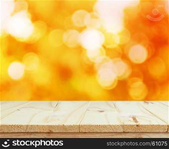 Wood table top on shiny bokeh gold background for display your products
