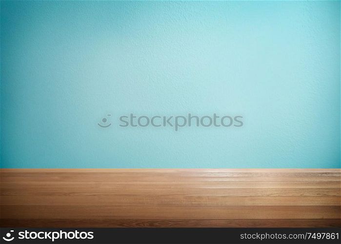 Wood table with mint blue background .