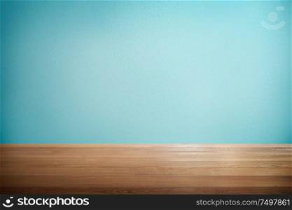 Wood table with mint blue background .