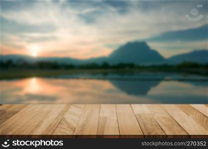 wood tabletop with blurred amazing landscape background.