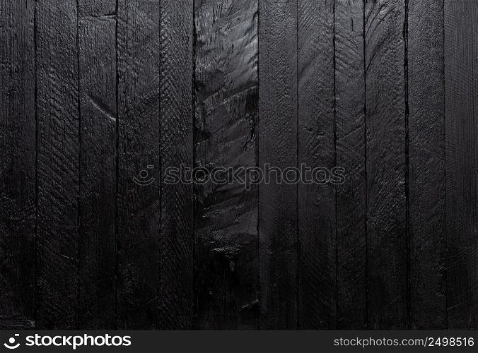Wood texture black dark painted table background top view.
