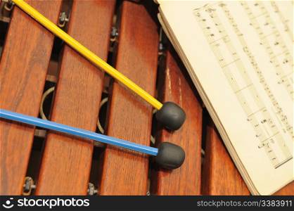 Wood xylophone with notes and mallets. A photo close up. Original color