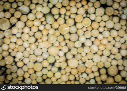 Wooden abstract background with a stack of round firewoods prepared for winter