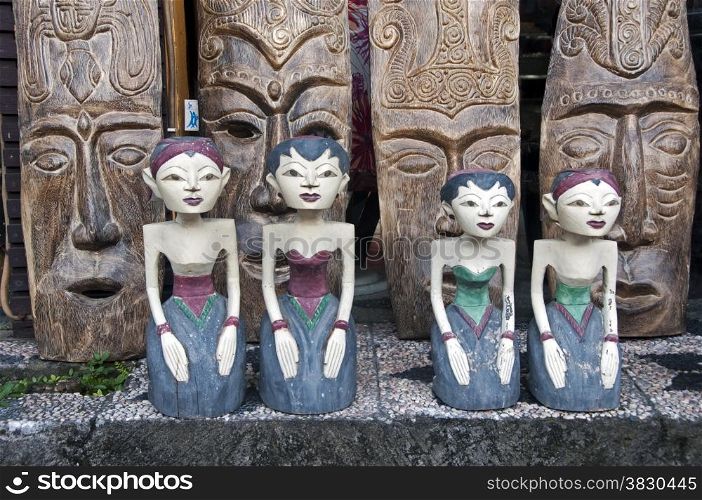 wooden art from grls and wooden mask from Bali on the background