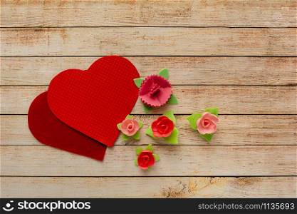 Wooden background with flowers and hearts. The concept of Valentine Day.